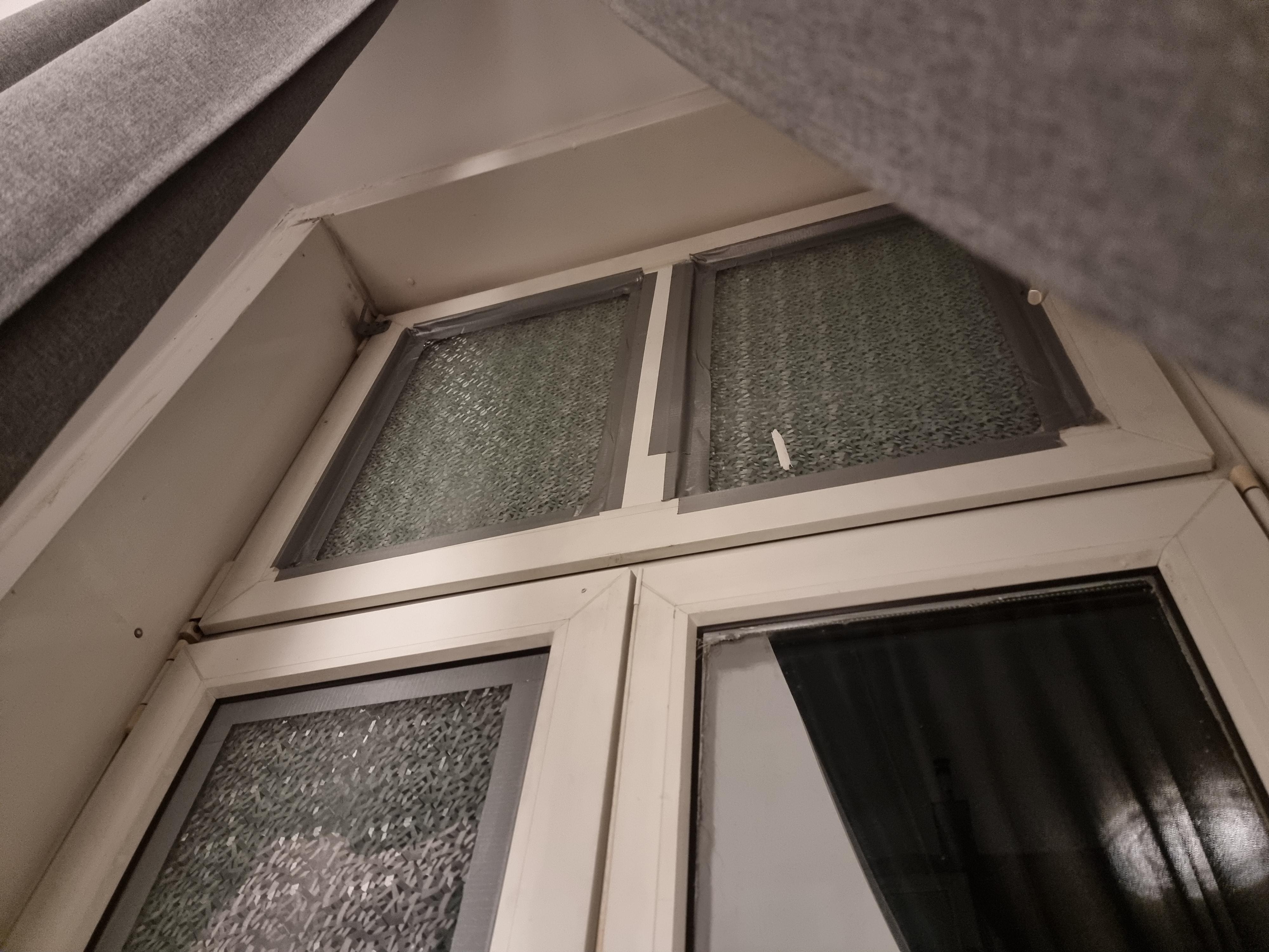 Windows held in with tape 