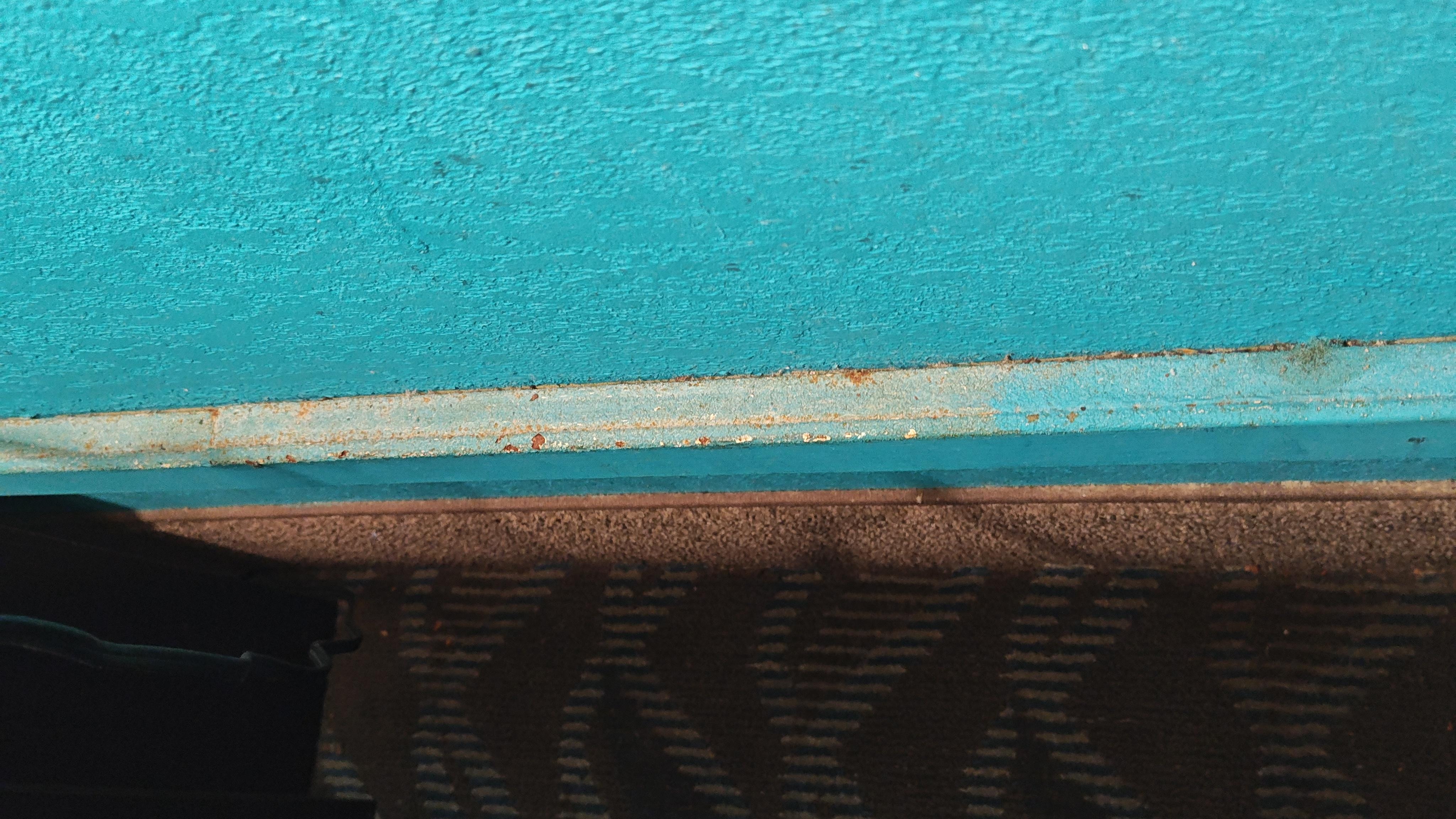 Dirt behind the bed.  Not terrible, but still dirty.