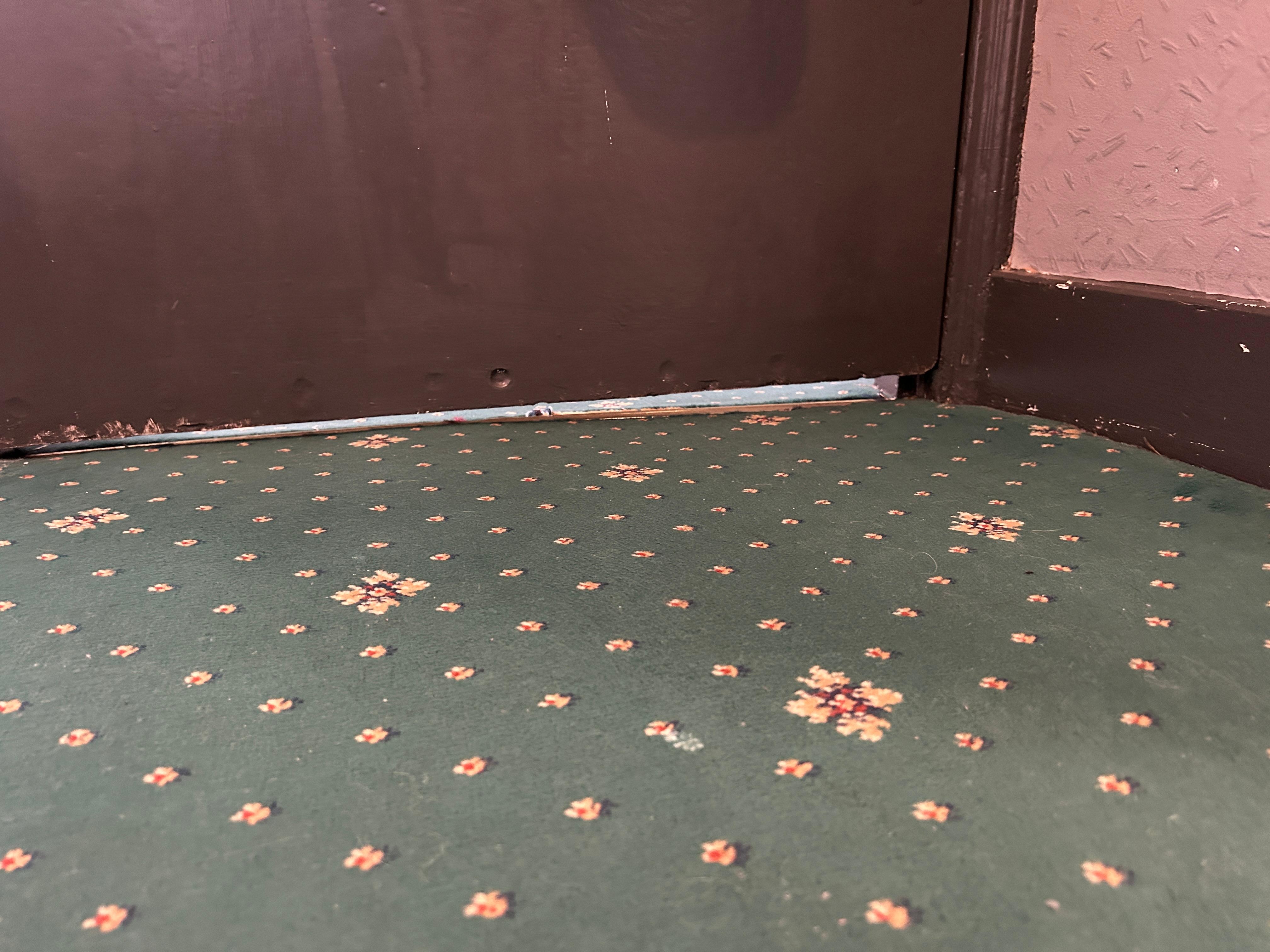 The gap under the door. Could hear other rooms on the corridor. Not fire-safe. 