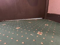 The gap under the door. Could hear other rooms on the corridor. Not fire-safe.