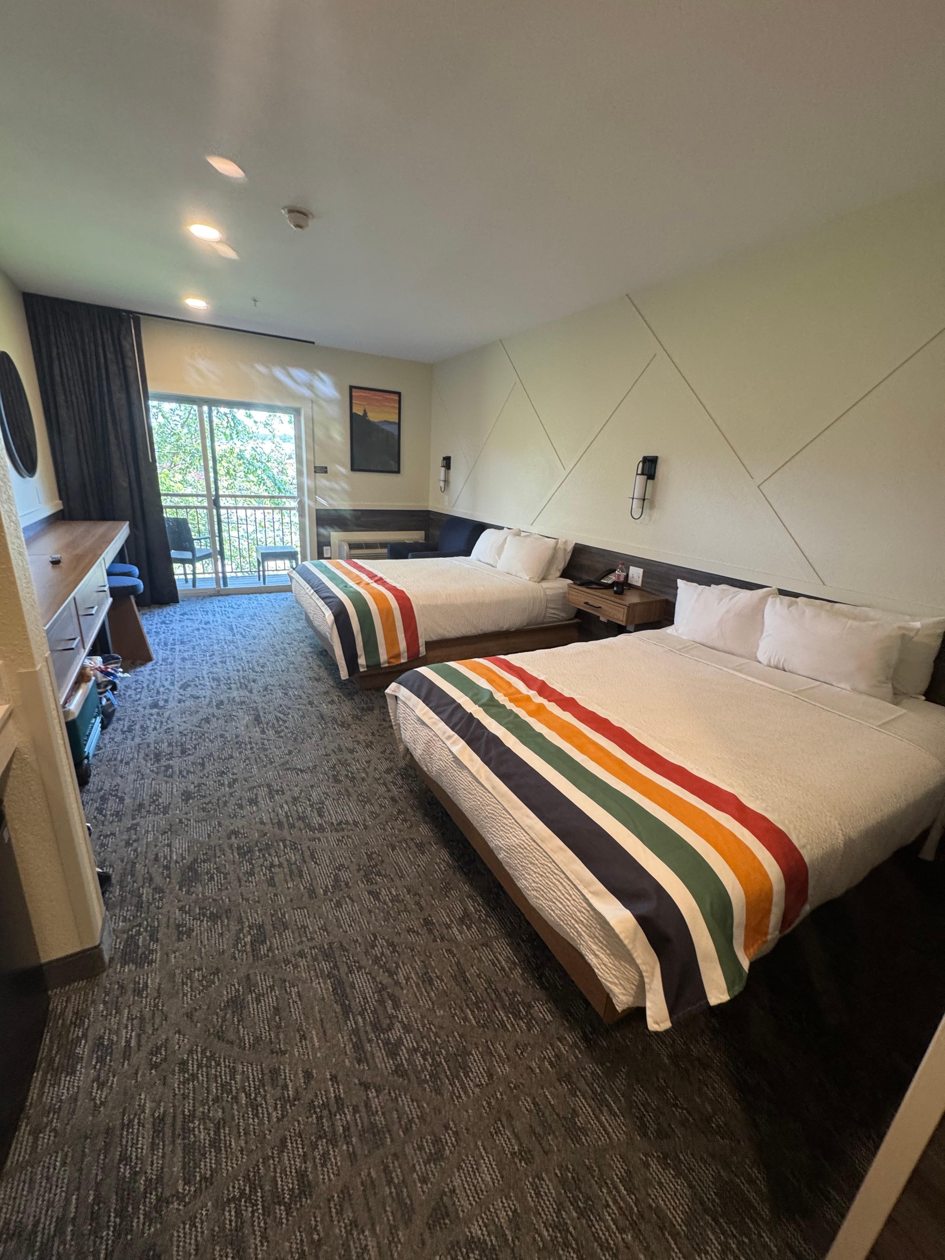 Two queen beds with a balcony