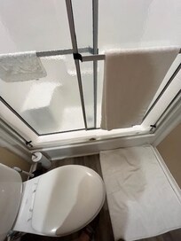 Broken shower door in 2nd bath