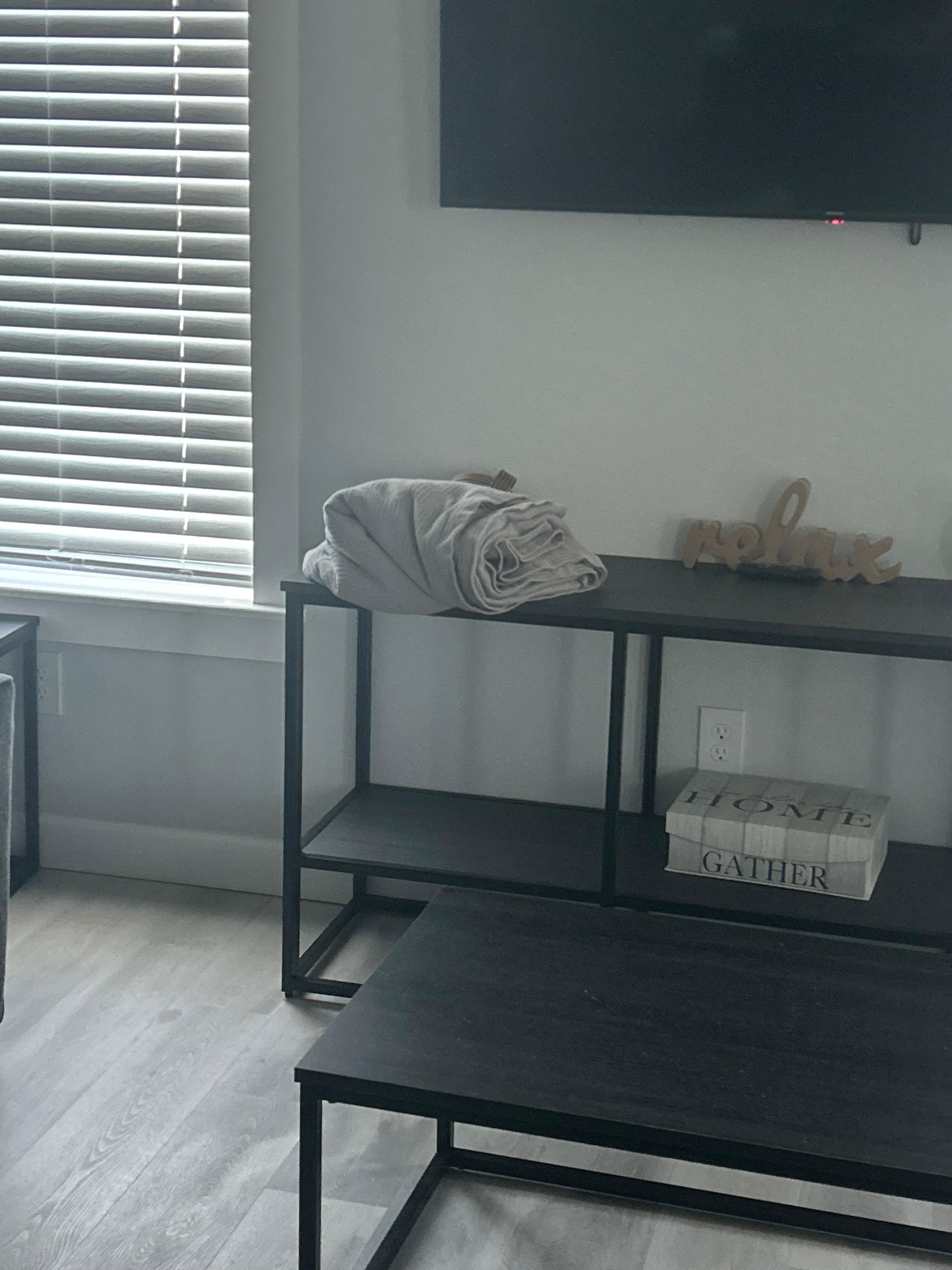 Dirty bedding in living room.