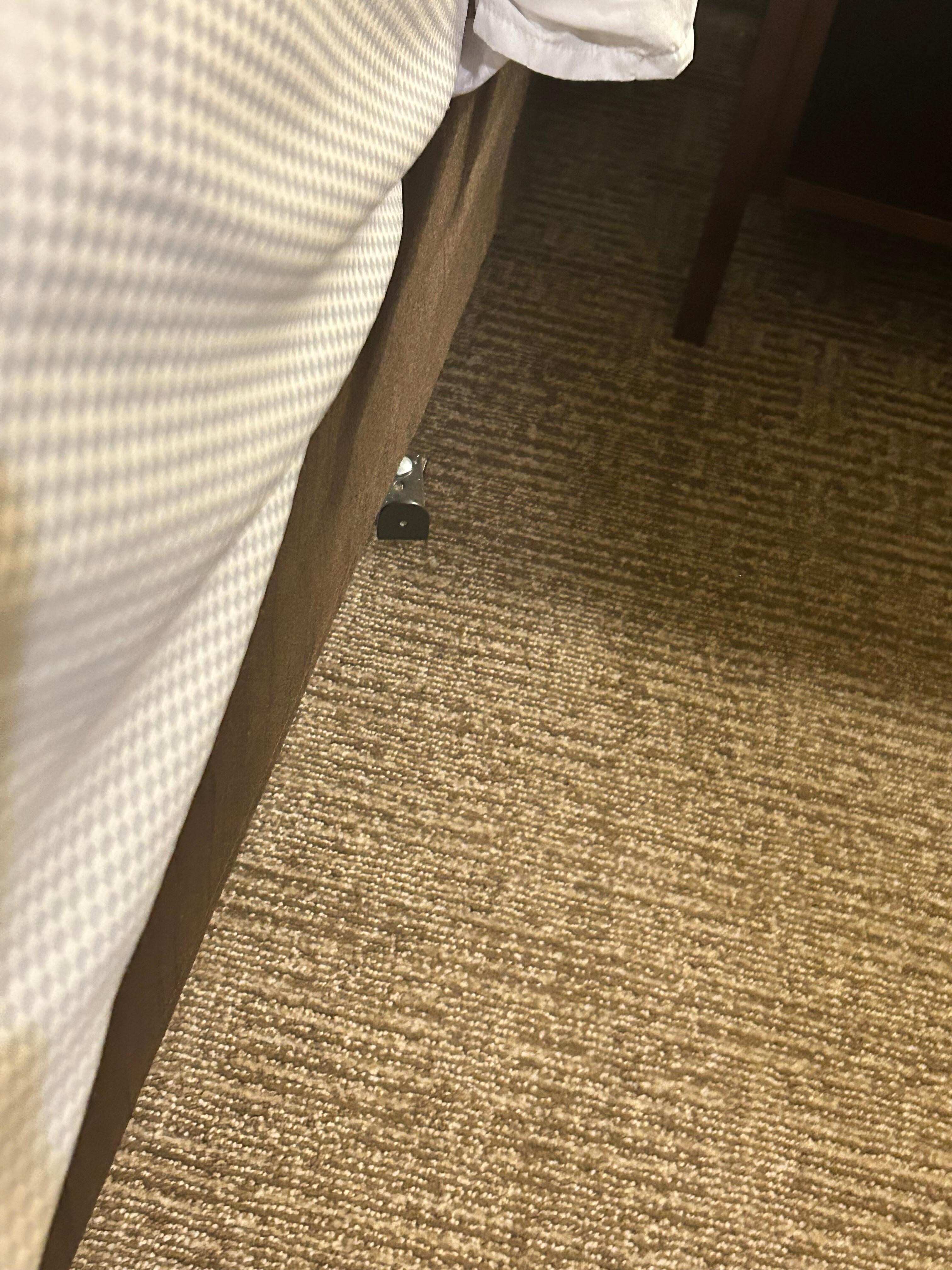 Room 115 metal piece sticking about 3 inches toward foot of bed