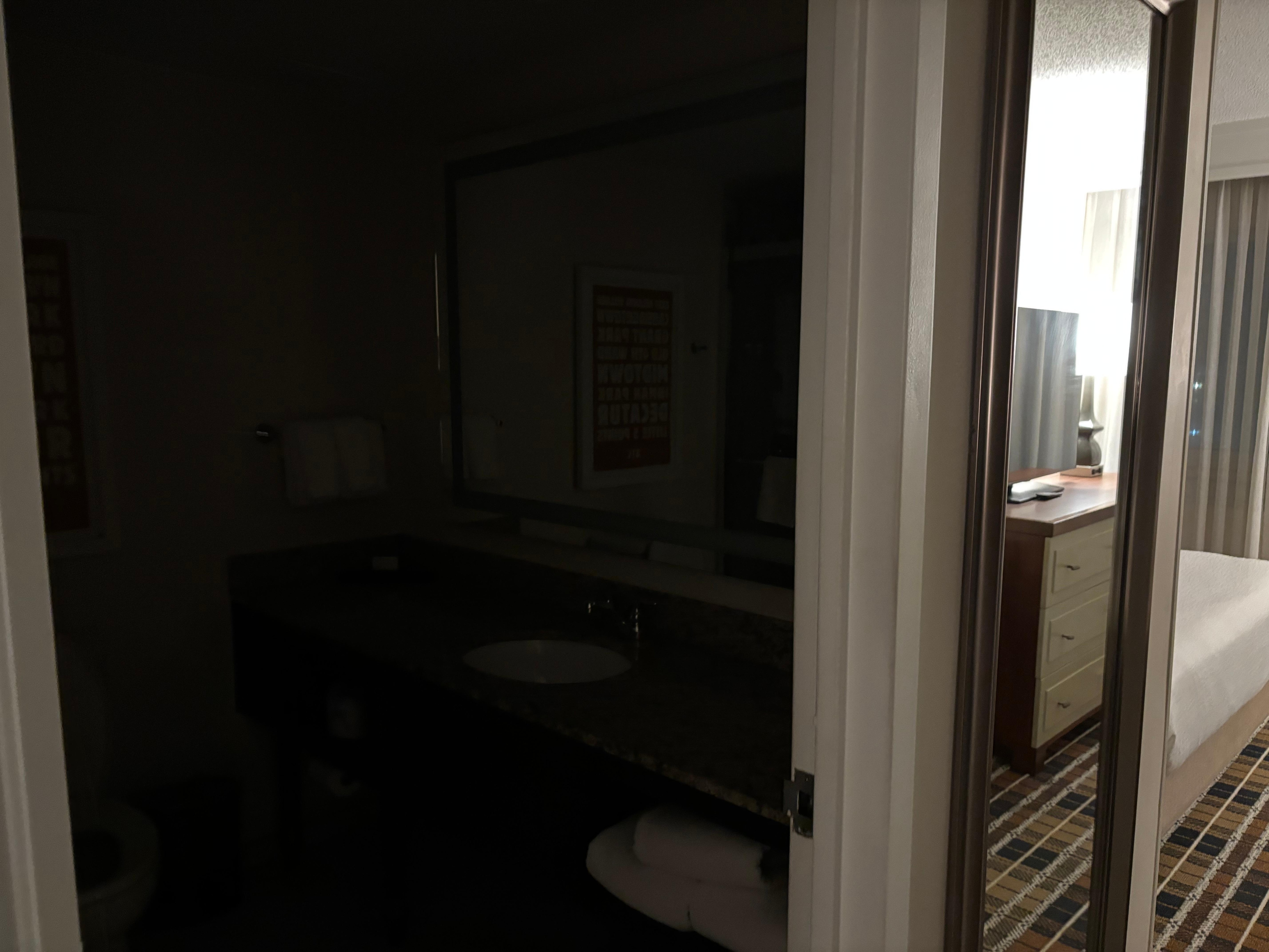 Hallway between sitting room and bedroom. Left is bathroom and right is closet. 