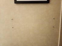 Bare holes left from the towel rack in the bathroom.
