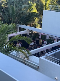 view from unit deck of bar/club in building next door with loud music