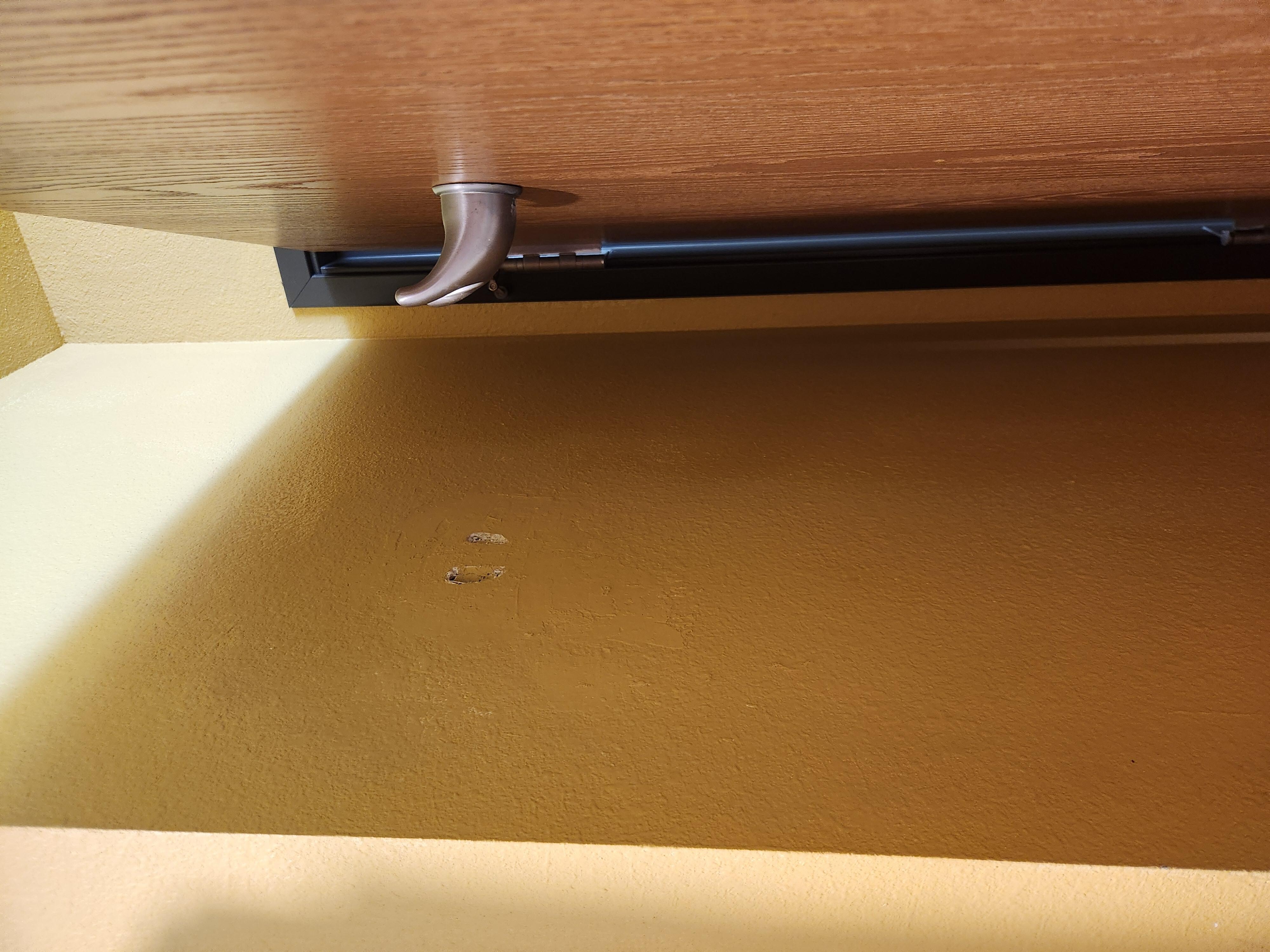 Holes from bathroom door
