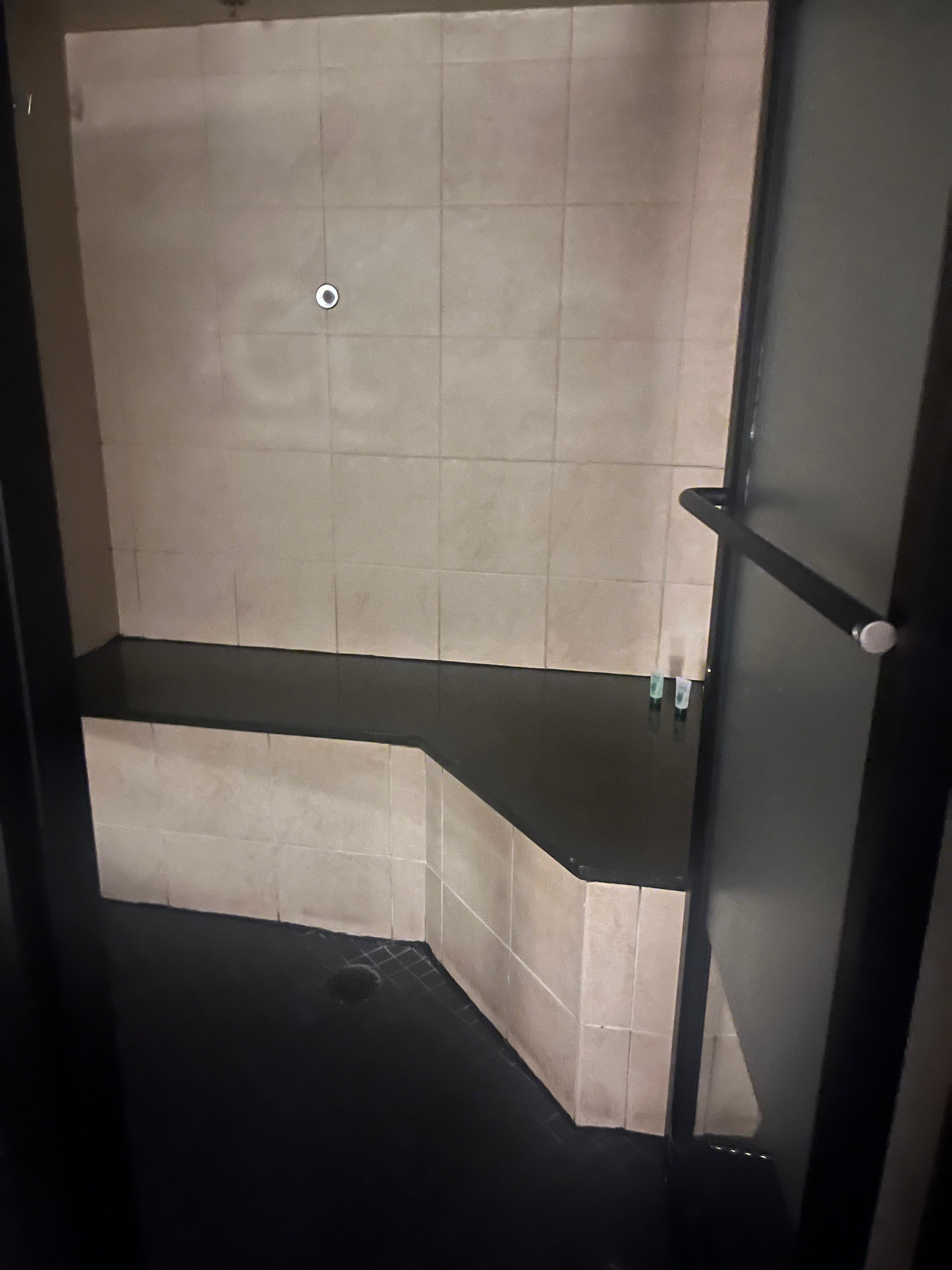 Broken shower with a door that doesn’t close 