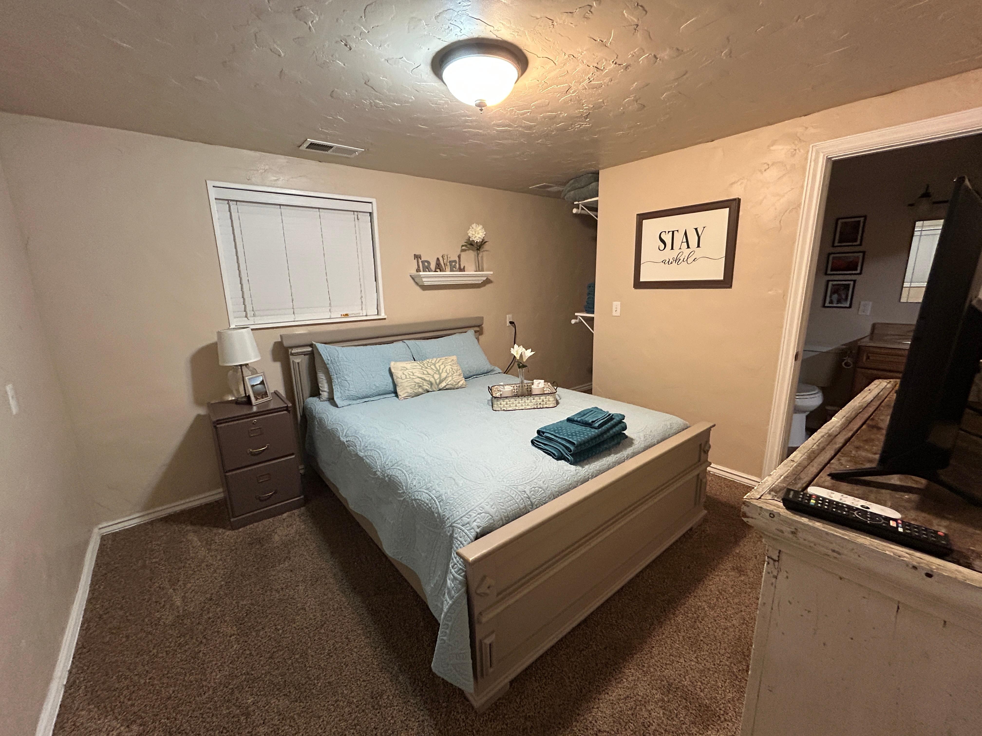 Bedroom (extra bedding, pillows, and towels were available—large open closet/storage area to the right at the head of the bed.