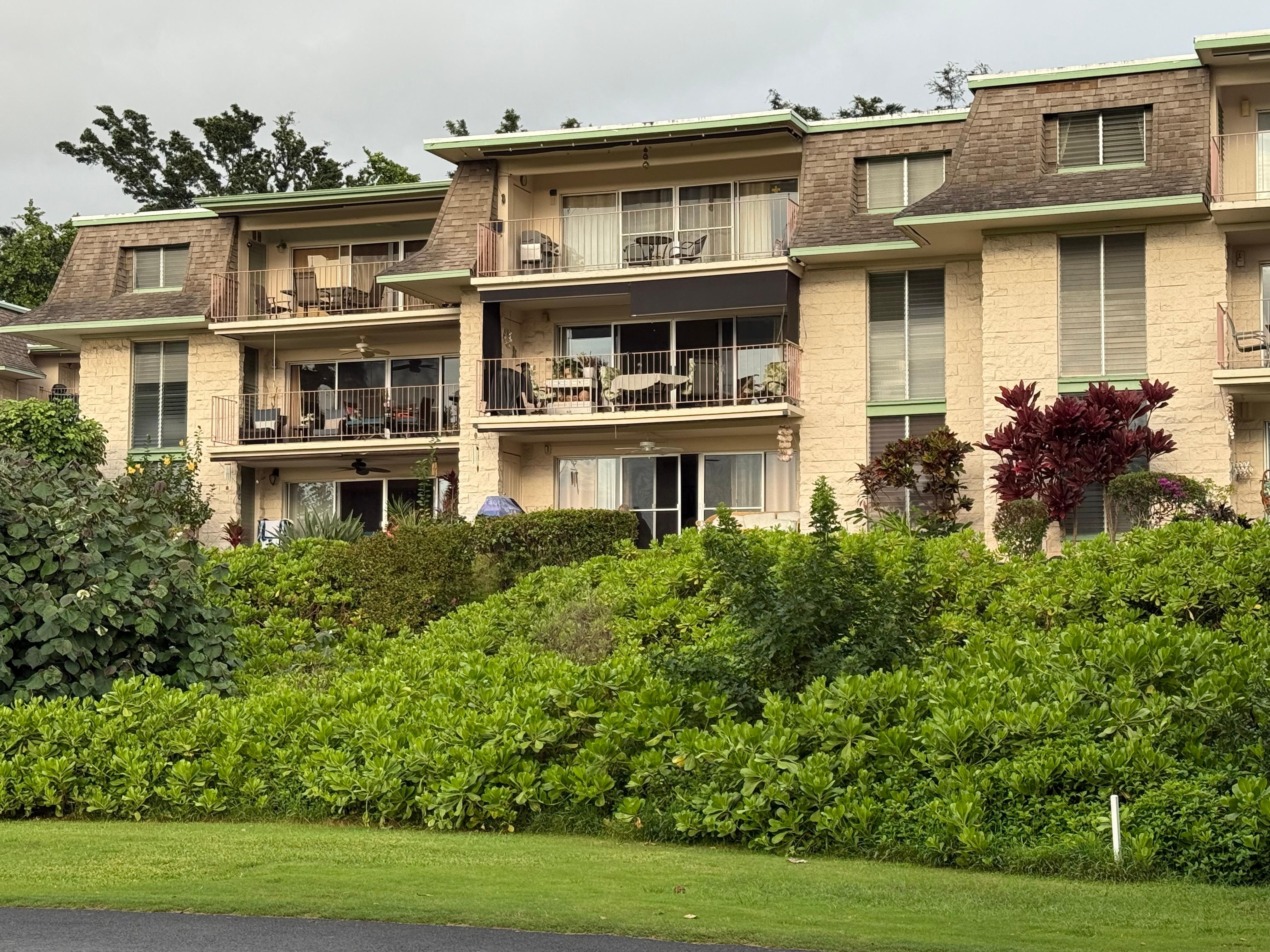 Units porch is center on bottom, facing garden and golf course with view of ocean. No stairs are needed to access first floor unit.