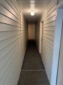 Burned out lights in hall leading to dark corners