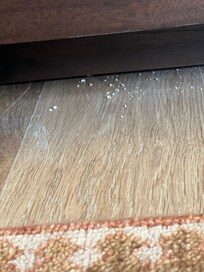 Visible from the couch, underneath the media console cabinet.