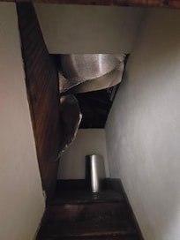 Stairs to attic we,initially, thought was a closet.Ceiling falling down and loose insulation. No way to secure the door shut.