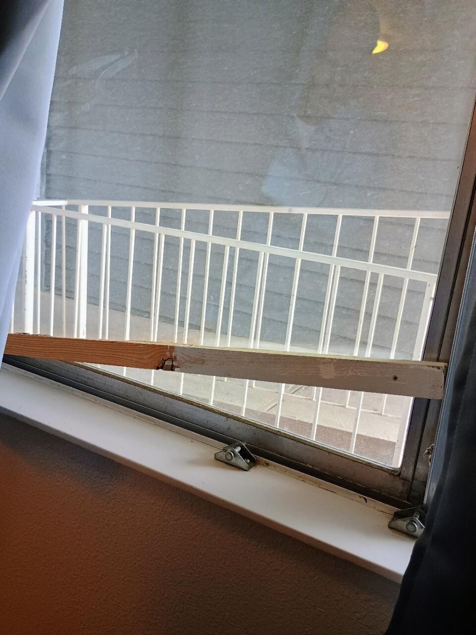 The window latch was broken.  This board is apparently their way of repairing it.
