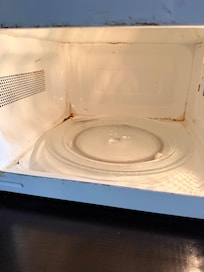 The microwave was broken (it did not spin) and was not cleaned at all.