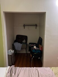 Closet with no lighting in an already dark room