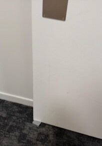 Fire door wedged open outside of the lift ground floor