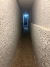 Creepy basement hallway. Cannot upload video of entire apartment.