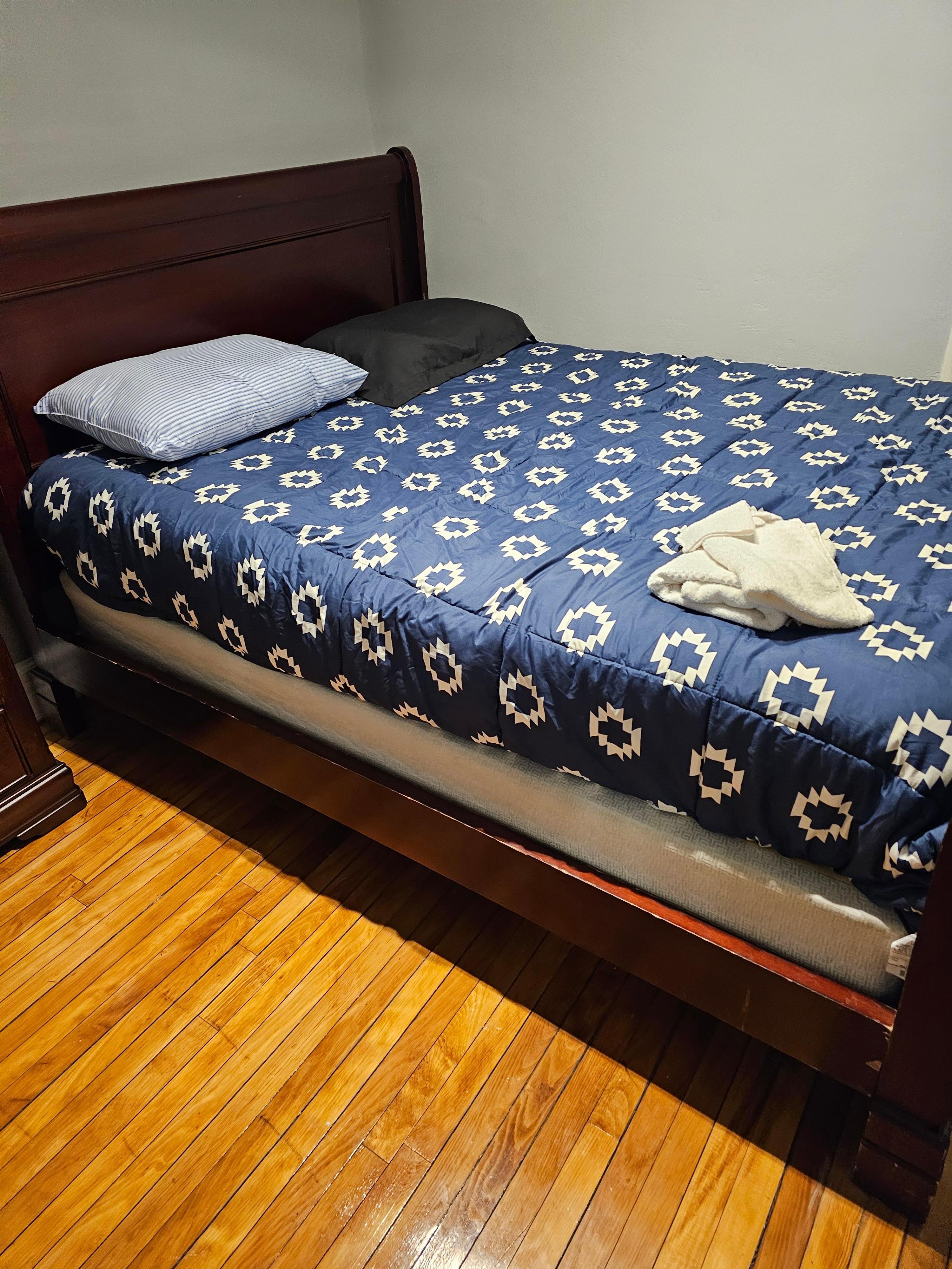 Two pillows one pillowcase. Community towel. Bed is broken underneath.