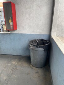 Neglected trash bin right outside the door