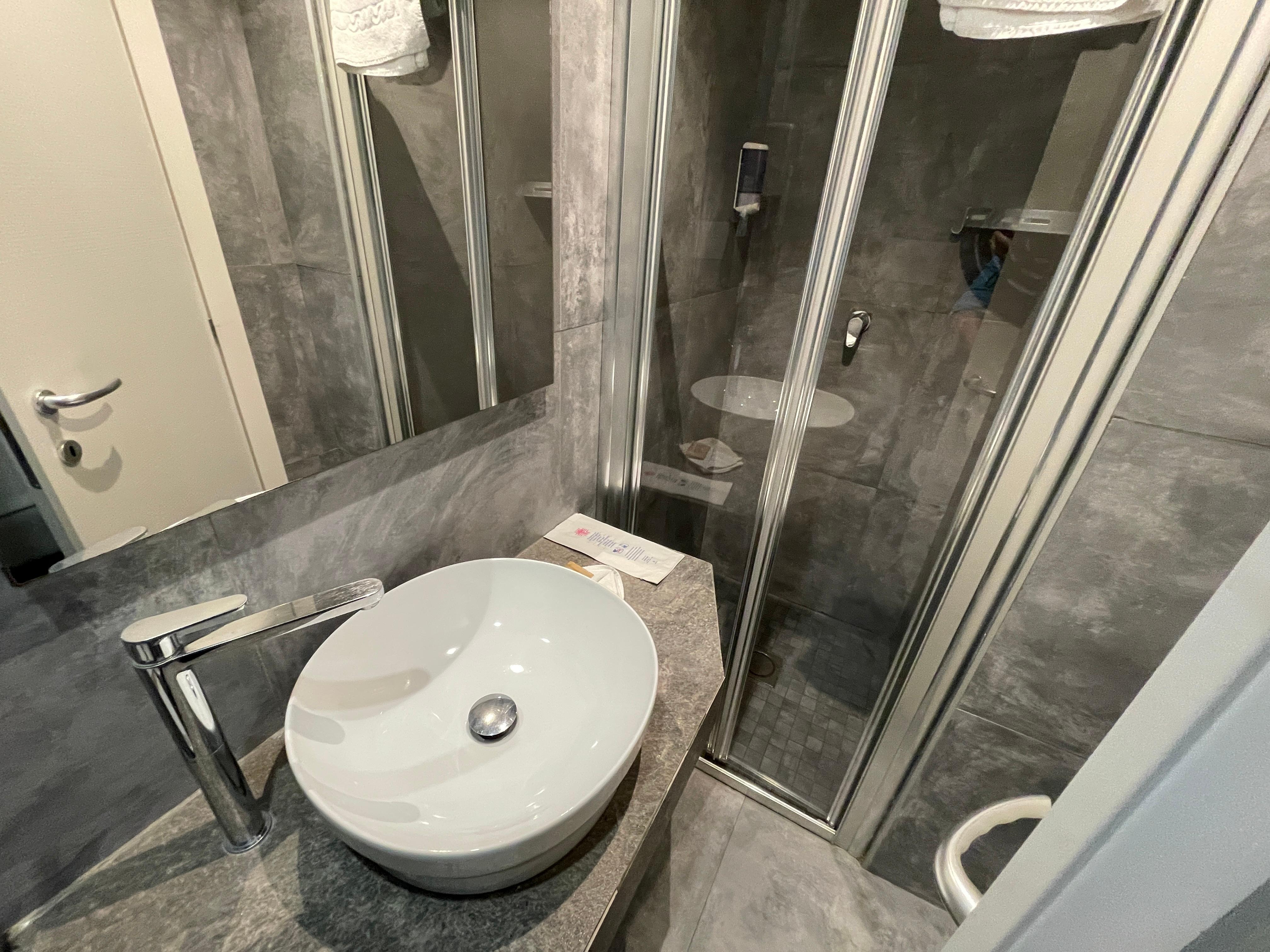 Vanity and shower, to get in shower you have to close the bathroom door 