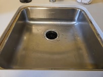 Kitchen sink caulking needs attention.