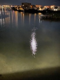 night view from balcony with moon reflecting off the water