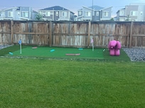 There is a putting green in the backyard.