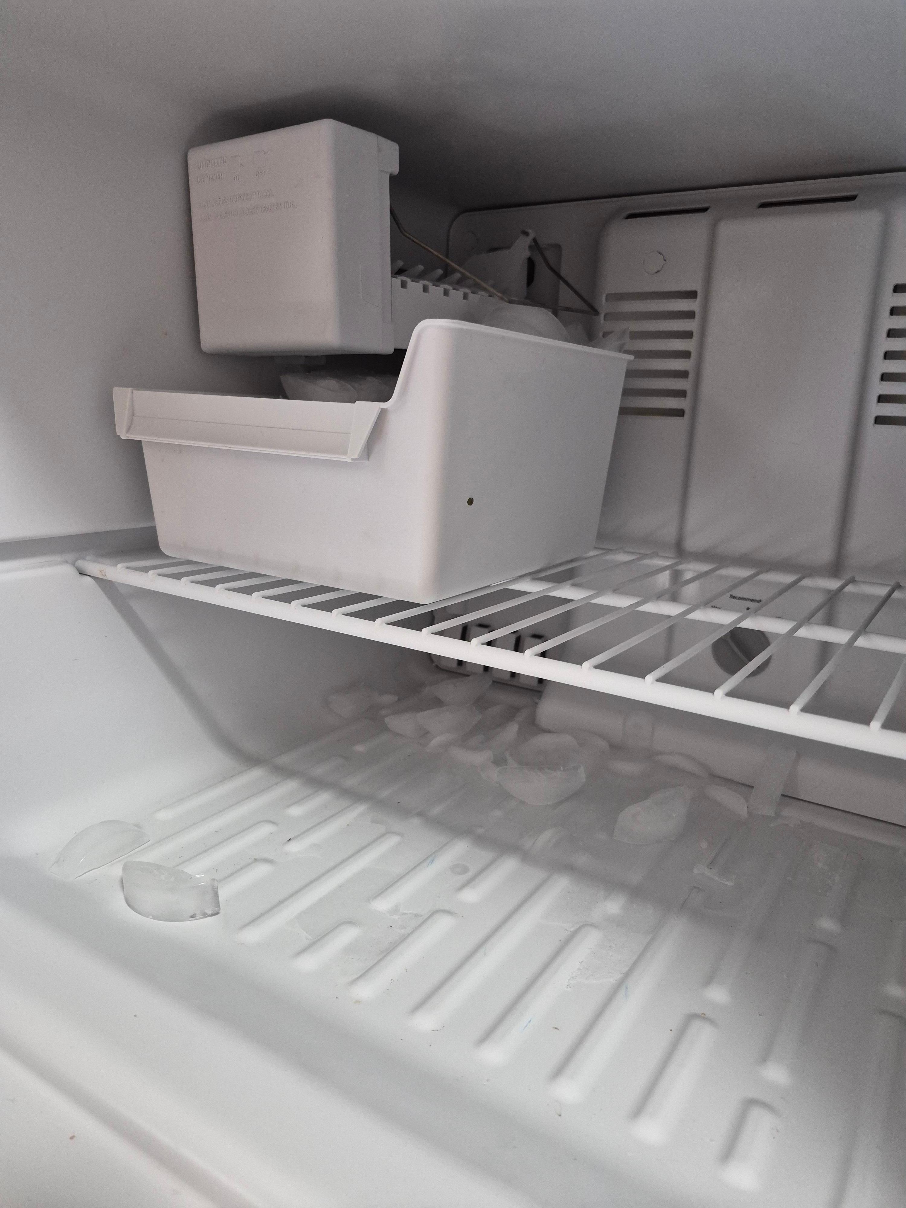 Ice cubes frozen to the bottom of freezer
