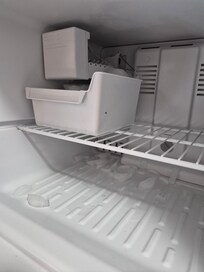 Ice cubes frozen to the bottom of freezer