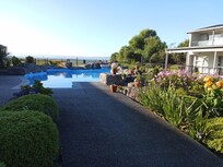 The lake is just beyond the property. Beautiful gardens and rockery surround the pool.