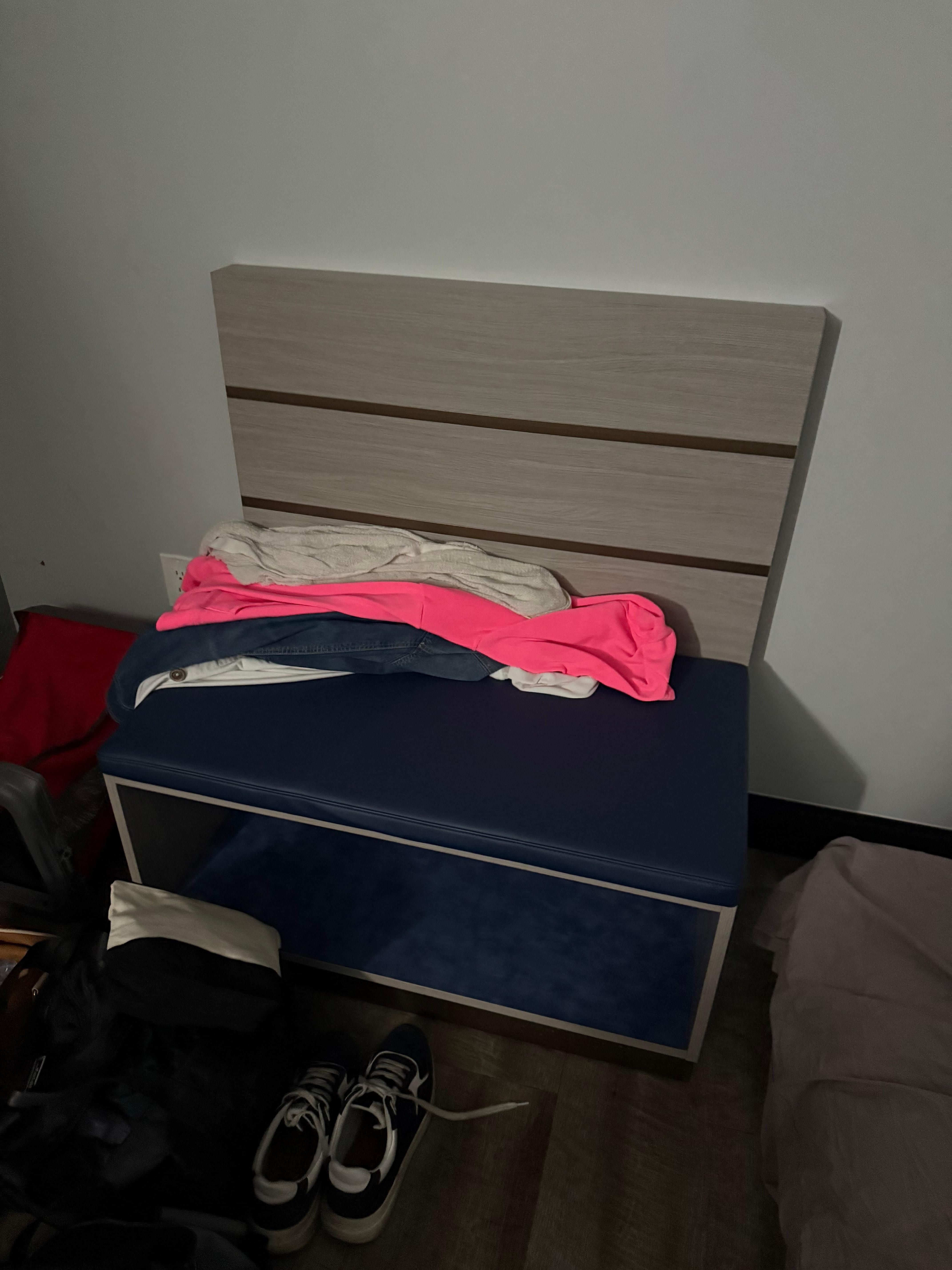 Odd looking bench in the back of the room your room was very spacious yet no Furniture