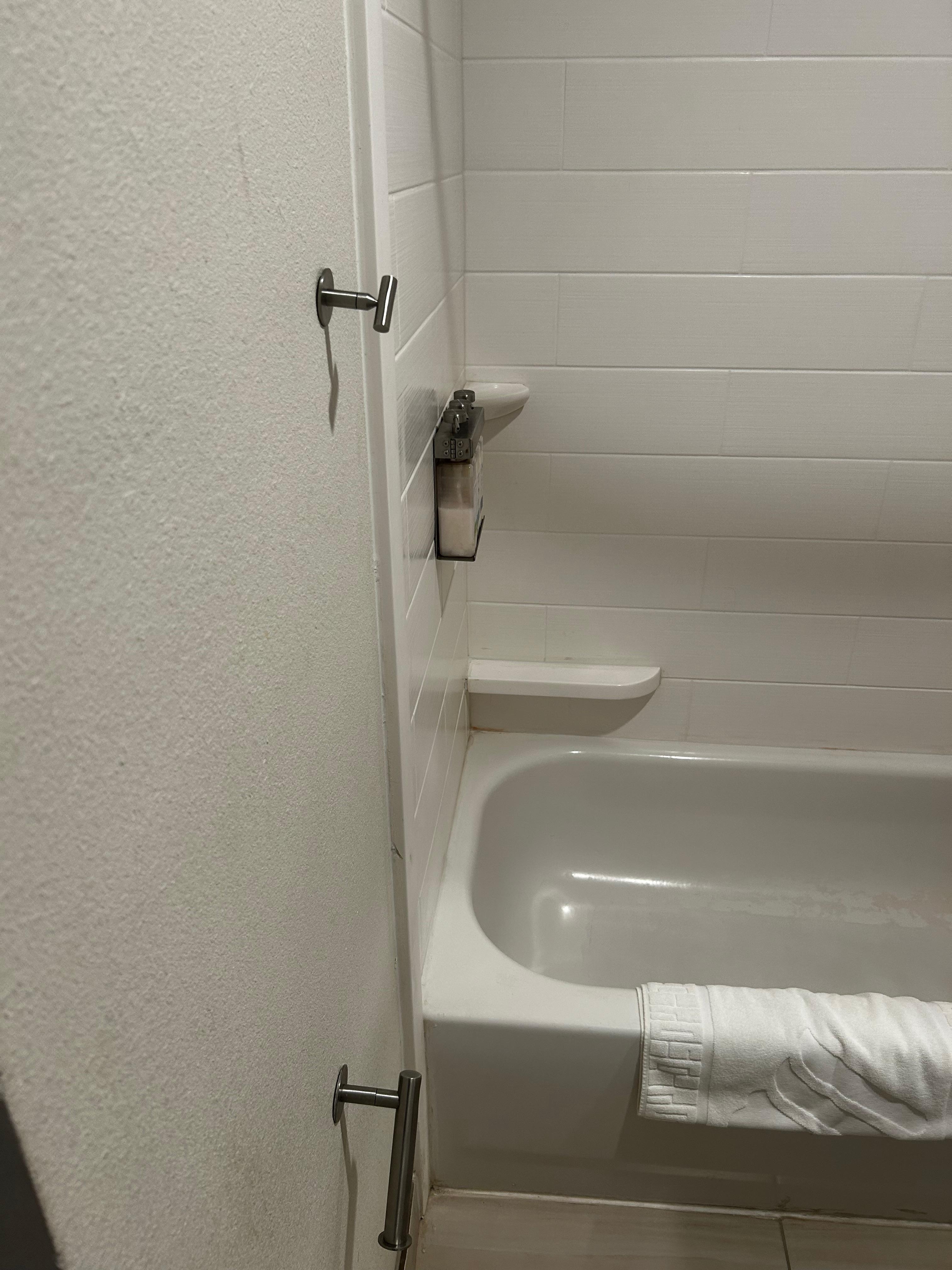 Tiny little hook, which I assume is for towels. It was about to fall out of the wall due to being so loose.