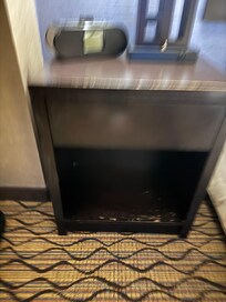 Chipped wood, dents, on the end tables. There was more on the desk in the room as well.