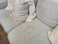 Living room furniture with stains and dog hair
