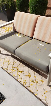 Torn and dirty cushions and deprie in outdoor seating area