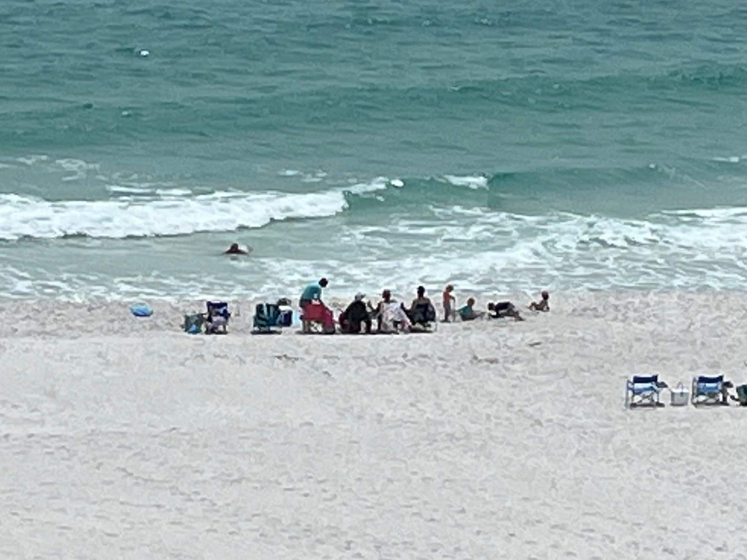 View of the family on the beach from the balcony. 