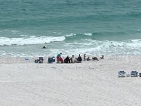 View of the family on the beach from the balcony.