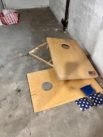 Broken corn hole in basement
