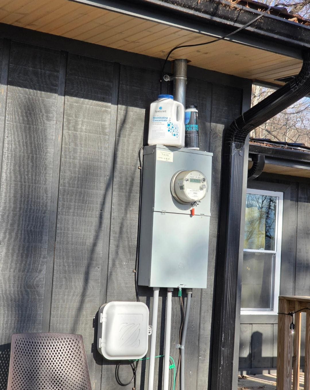 Chemicals and electric box, wires run right over hot tub, maybe 10 feet high