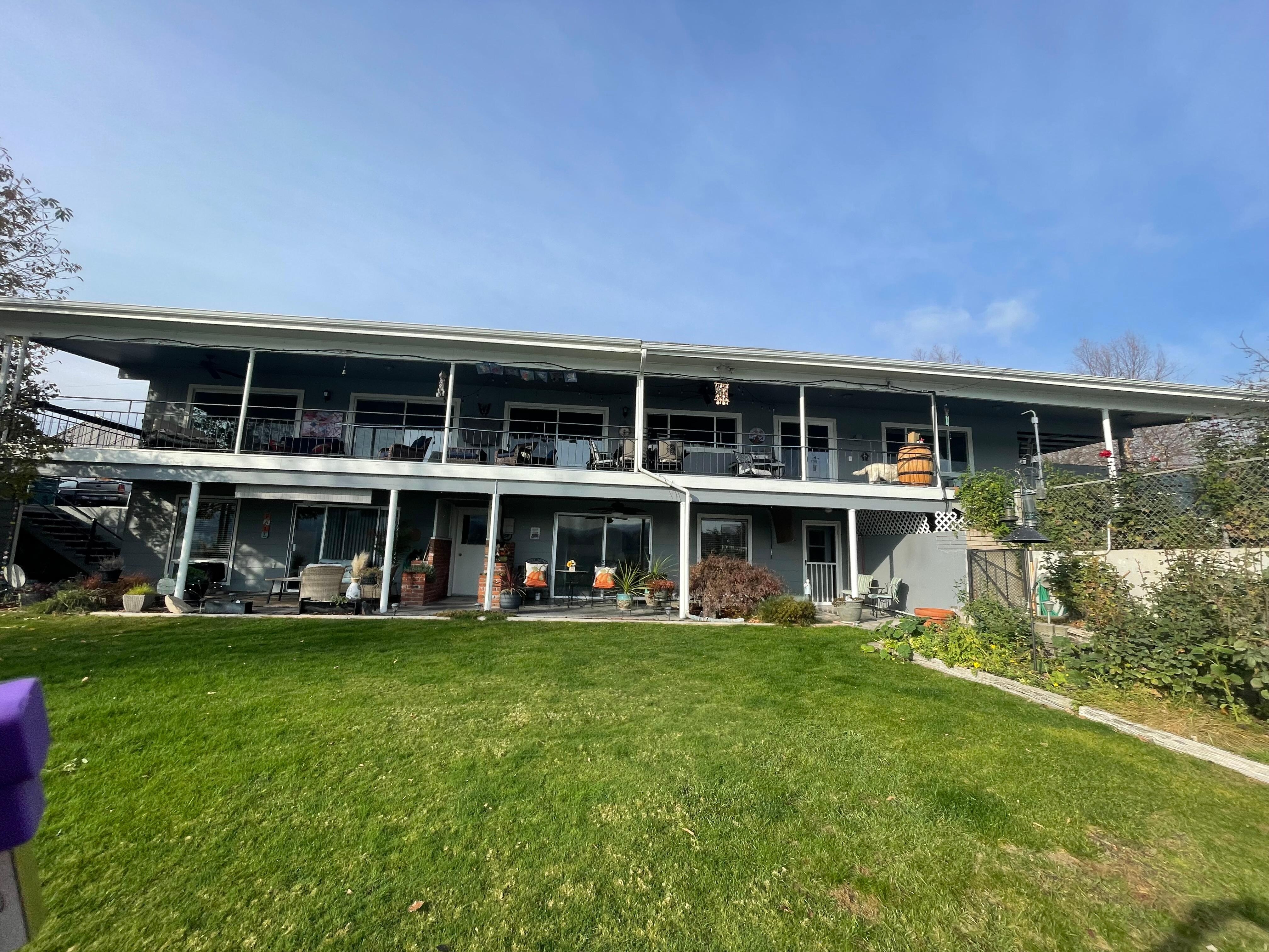Facing the house from back yard  by  fence overlooking the river