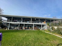 Facing the house from back yard by fence overlooking the river