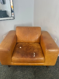 Why is this torn up and stained chair even in the room?