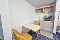 Kitchenette area in the room with dining seats and table space