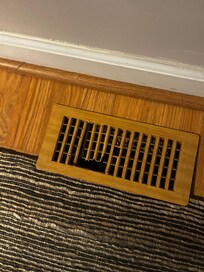 Broken ac vent cover in dining area and kitchen offset from sink.