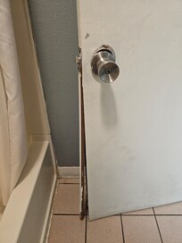 Door to bathroom is falling apart.