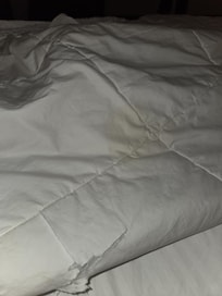 Yellow stain and tear in the comforter