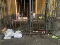 Another photo of the entrance with trash.
