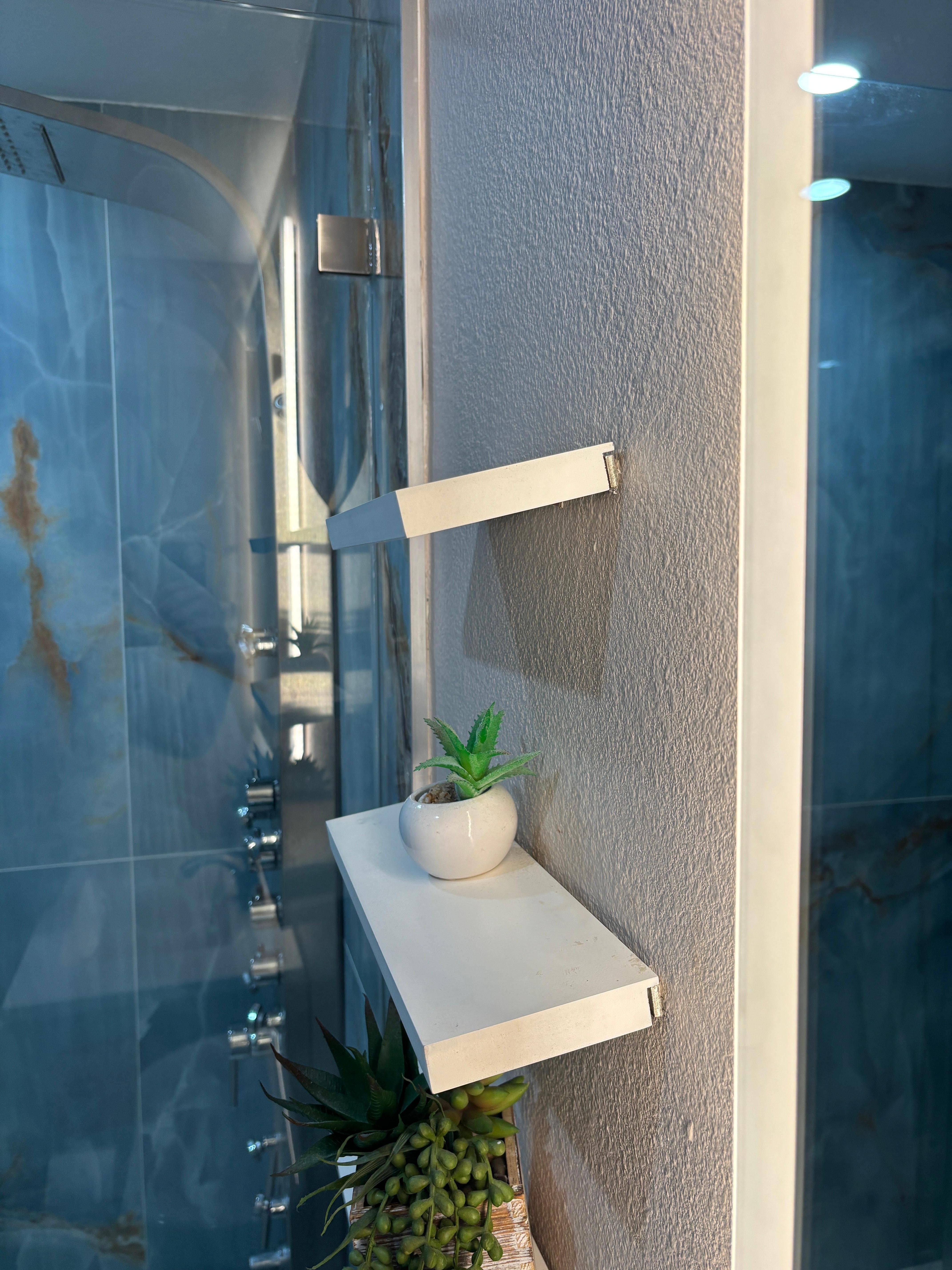 Floating shelves in master bath are still leaning down and are loose. 